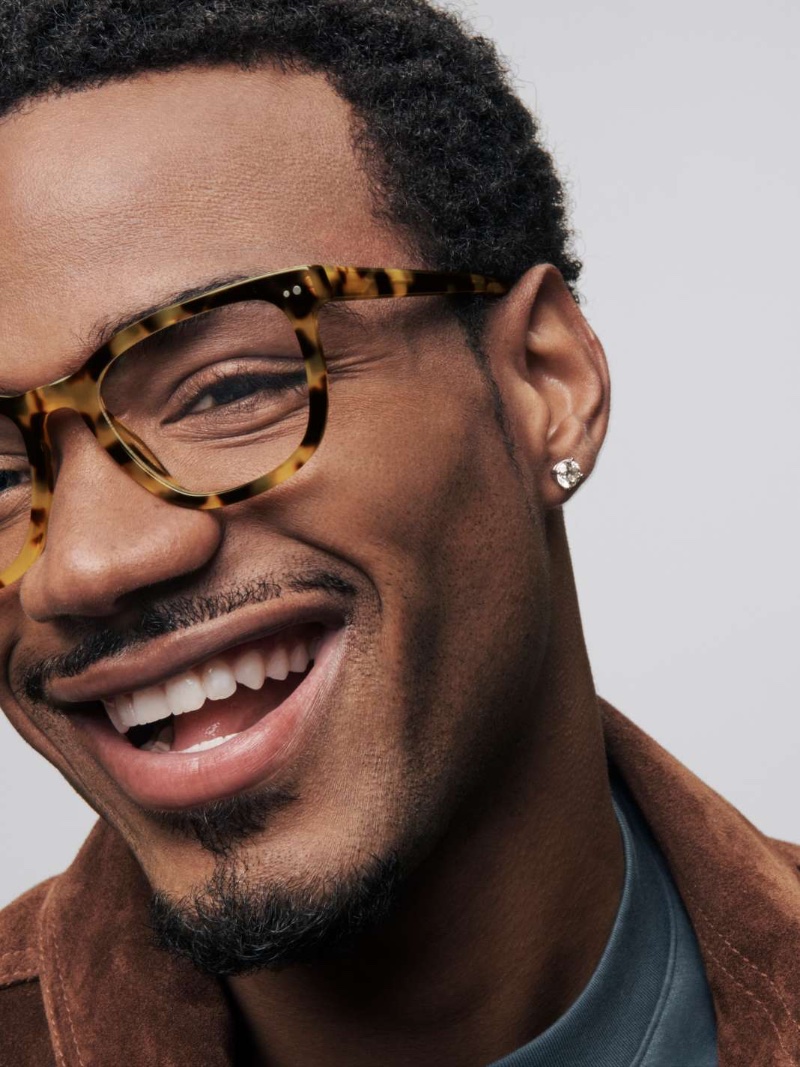 All smiles, skateboarder Tyshawn Jones dons Warby Parker's Toni glasses in Cider Tortoise. 