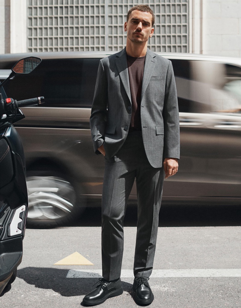 Reuniting with Mango, Antoine Griezmann dons a pinstripe wool slim-fit suit with a cotton t-shirt from the brand's new Performance collection.