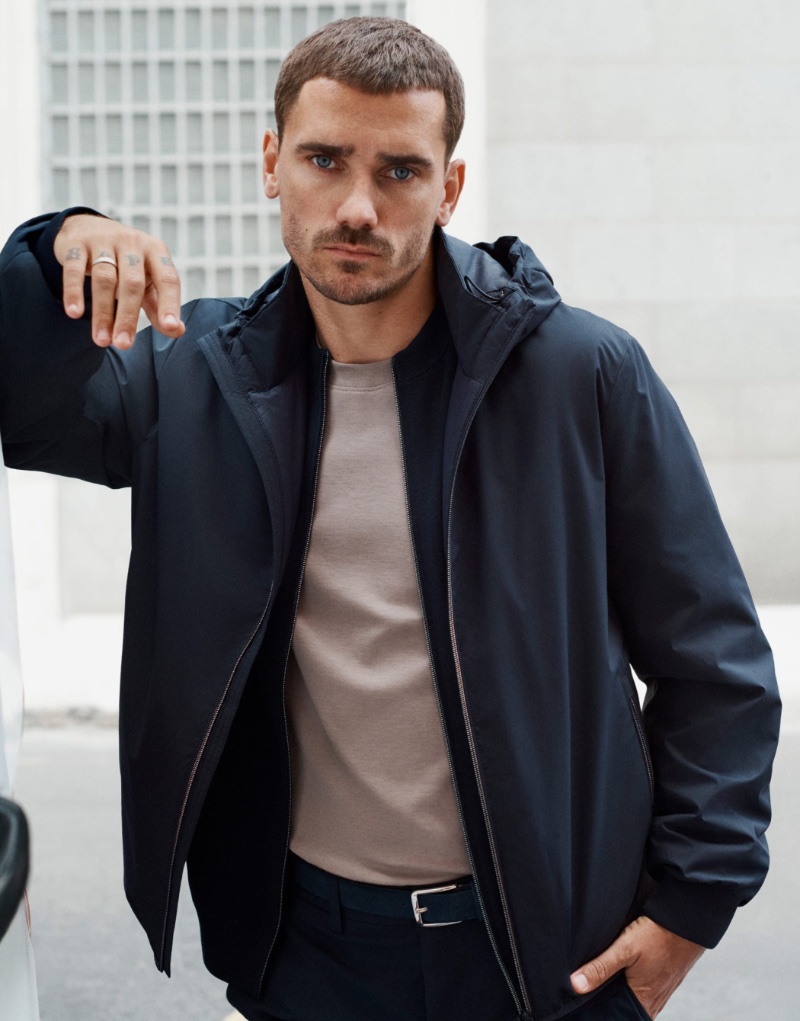 Going sporty, Antoine Griezmann rocks a water-repellent hooded quilted jacket and thermo-regulating zippered cardigan with a slim-fit stretch trousers from the Mango's Performance collection. 