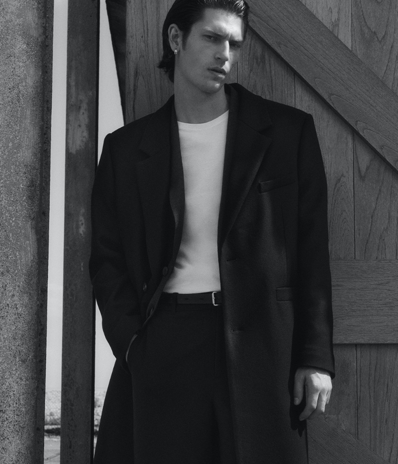 Model Justin Eric Martin dons a tailored wool overcoat by COS. 