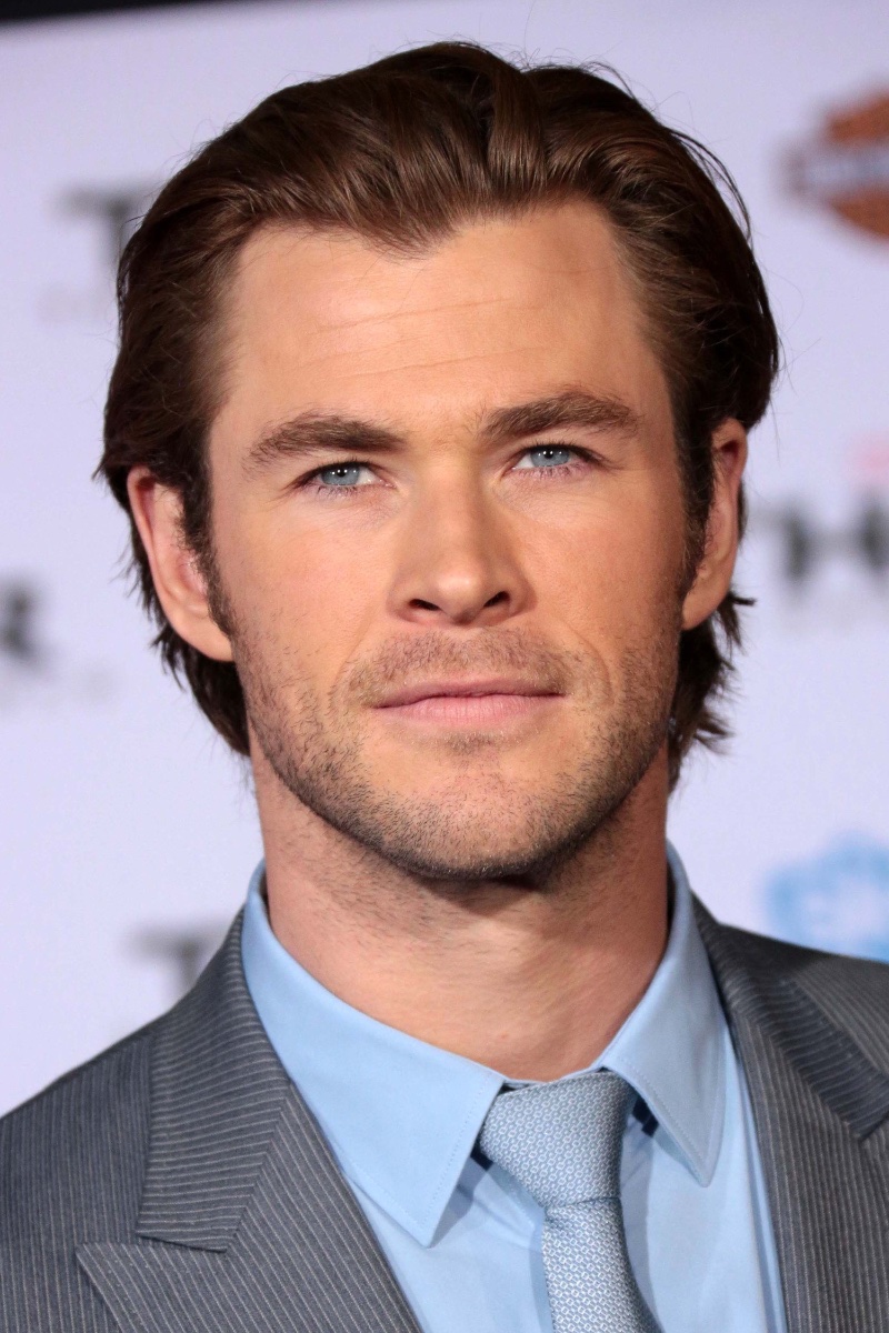 Chris Hemsworth graces the red carpet, opting for a slicked-back look that adds a touch of timeless elegance.