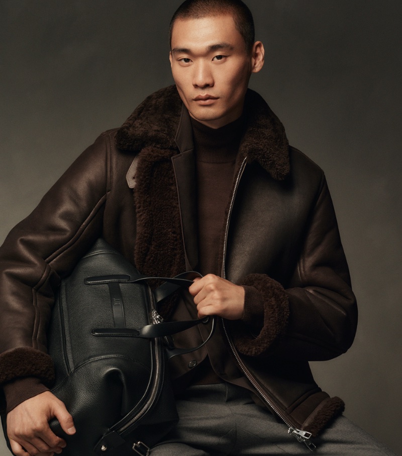 Kamui T models a shearling jacket for Dunhill's fall-winter 2023 campaign.