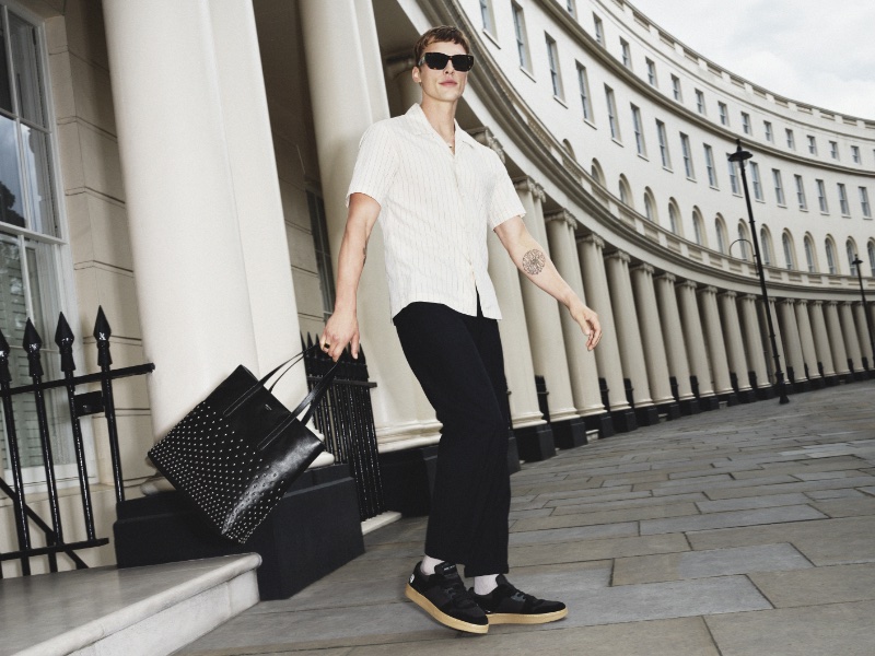 Sporting Jimmy Choo's Florent sneakers and holding a Pimlico studded tote, Charlie Florence appears in Jimmy Choo's fall 2023 campaign.