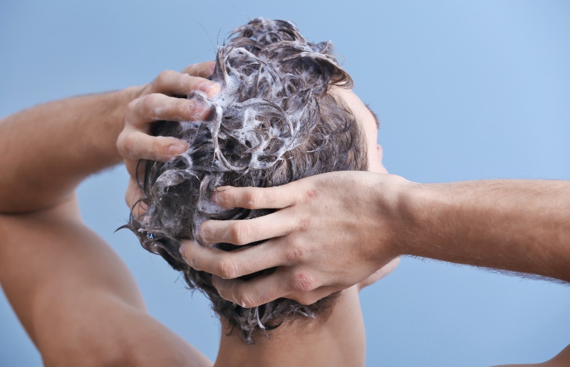 Man Washing Hair Blue Background