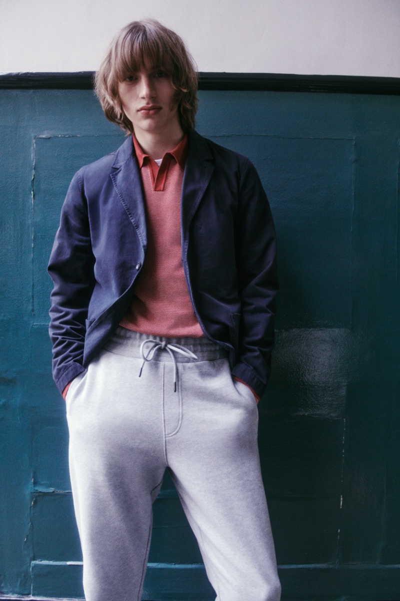 Model Dom Fellows sports joggers with a polo shirt and blazer. 
