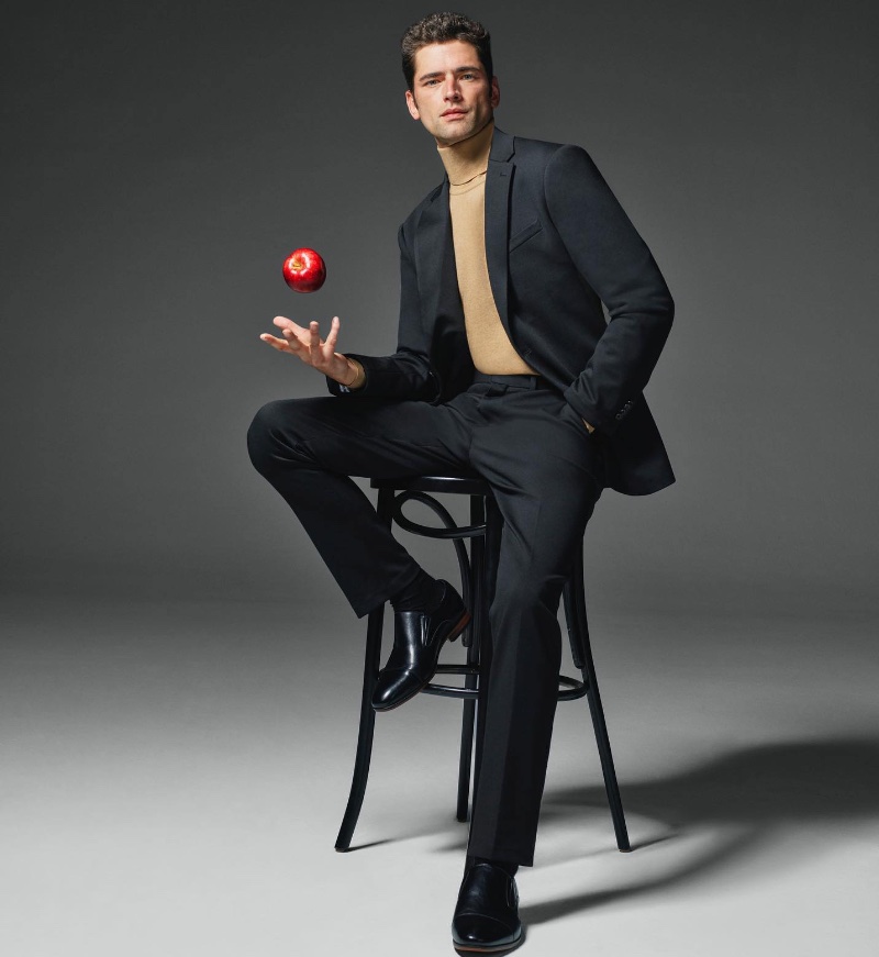 Model Sean O'Pry wears a turtleneck sweater with a suit for Perry Ellis' fall-winter 2023 campaign.