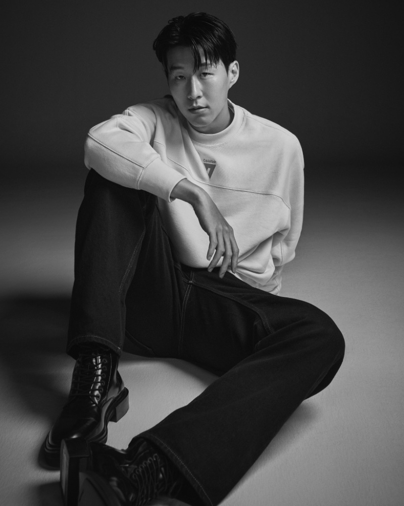 Son Heung-min wears a Calvin Klein sweatshirt from his limited-edition capsule with baggy jeans in black. 