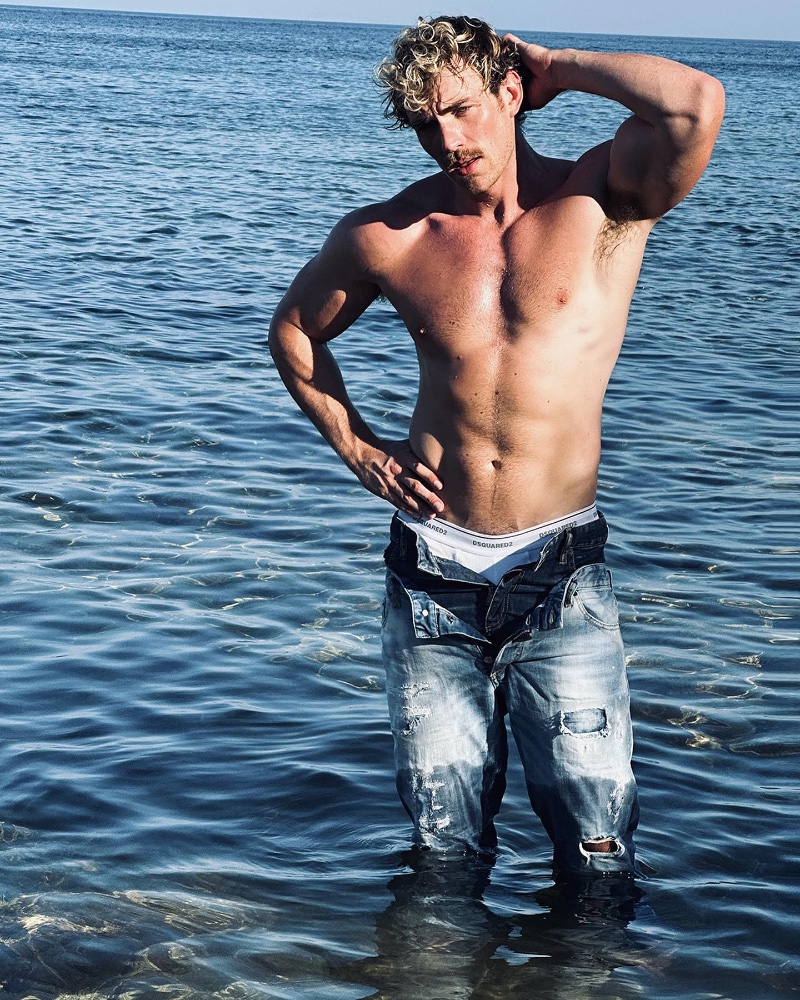 Zane Phillips poses shirtless, rocking a pair of Dsquared2 Light Ripped Wash Skinny Twin Pack Jeans. 