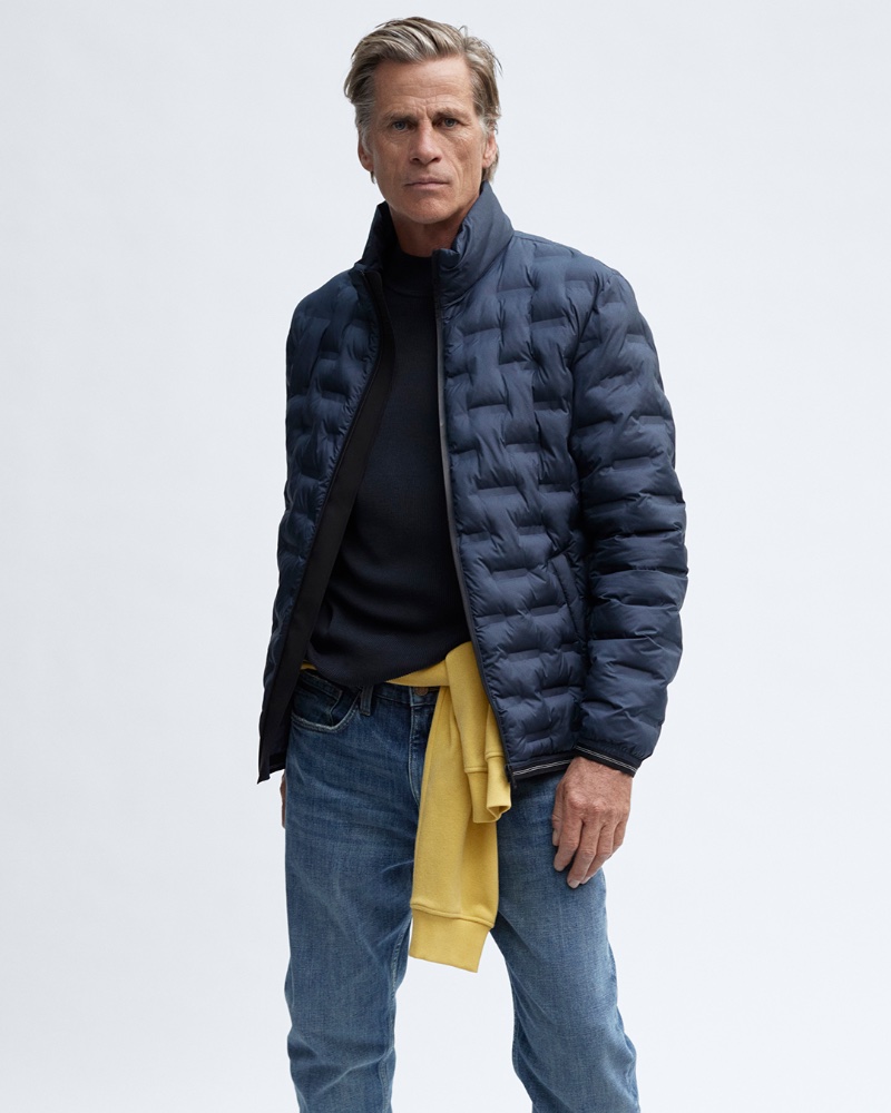 Taking the spotlight for fall-winter 2023, Mark Vanderloo wears a s.Oliver puffer jacket with distressed jeans.