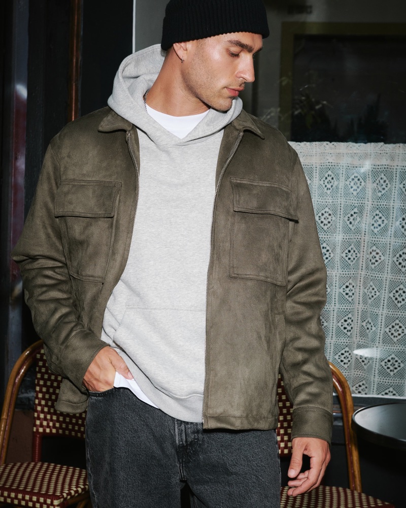 Model Jordan Addesi wears a vegan suede zip shirt jacket by Abercrombie & Fitch. 