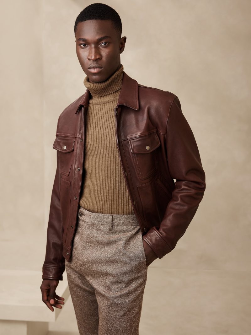 A buttery soft leather jacket in brown complements the elegant nature of the turtleneck sweater. 