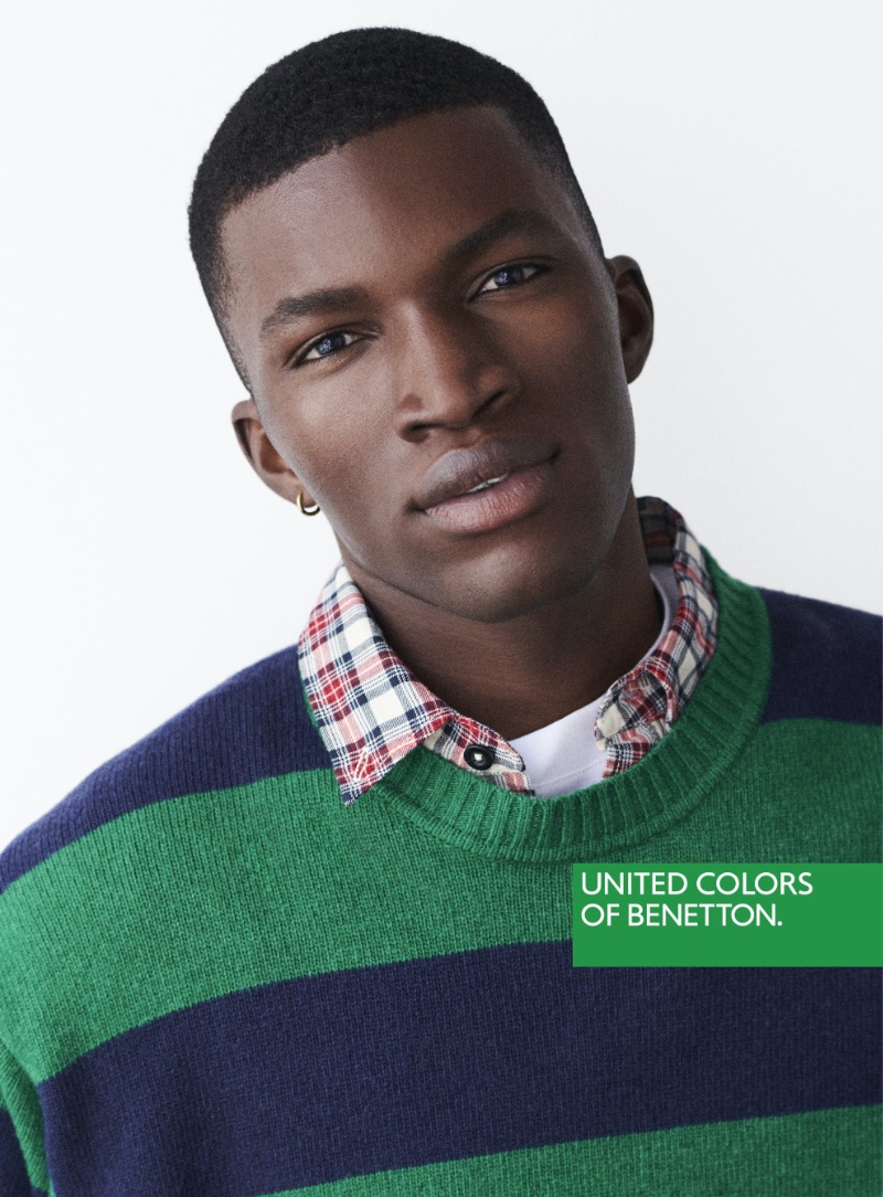 Abdoul Razak rocks a striped sweater and a check shirt for United Colors of Benetton's fall-winter 2023 campaign. 