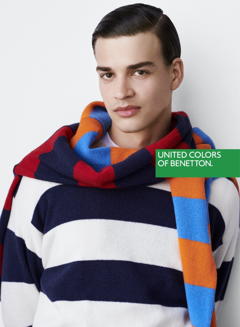 Andreas Athanasopoulos dons a striped sweater and scarf for United Colors of Benetton's fall-winter 2023 campaign.