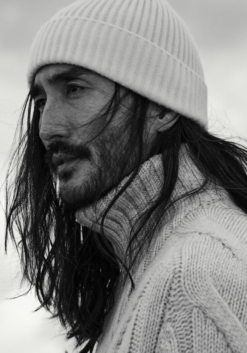 Model Tony Thornburg is winter-ready in a ribbed beanie and cable-knit sweater.