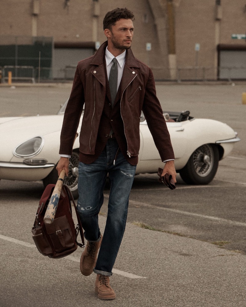 Sporting unusual fall layers, Harvey Haydon wears a Brunello Cucinelli shearling biker jacket over a deconstructed blazer with a shirt, tie, and jeans.