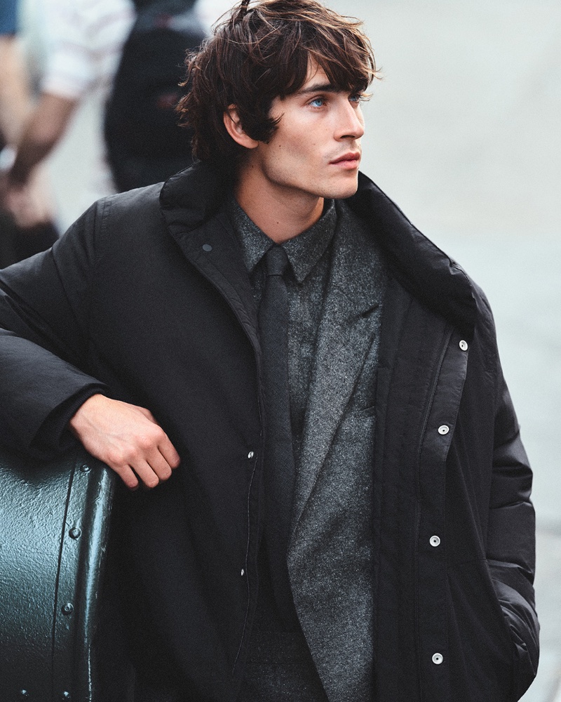 Making a sartorial statement, Liam Kelly models a COS puffer jacket over a wool-blend suit.