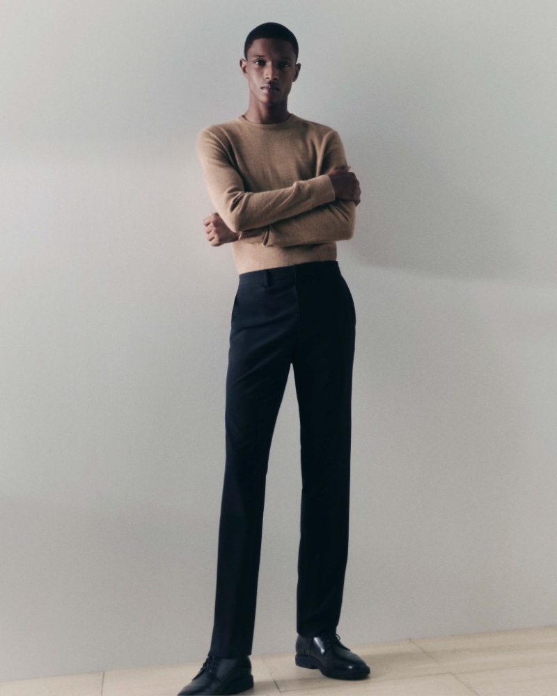 Malik Anderson is a chic vision in a camel-colored sweater with trousers for Calvin Klein's fall-winter 2023 essentials campaign. 