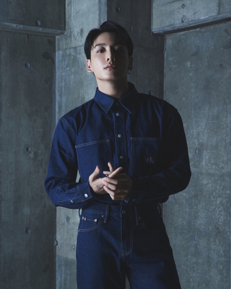 Jung Kook doubles down on classic denim in a snap button shirt and jeans.