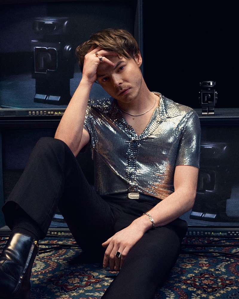 Actor and musician Charlie Heaton dons a silver short-sleeve shirt for Rabanne's Phantom Parfum advertising campaign.