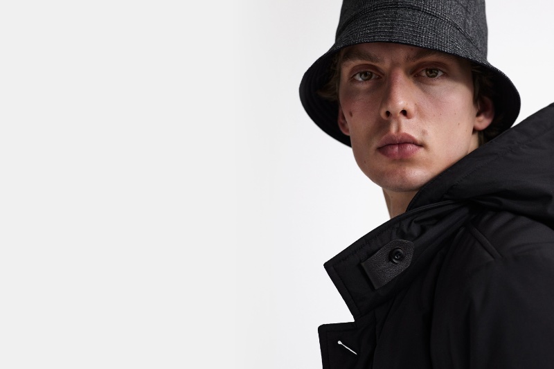 Leon Dame wears a grey wool and cashmere bucket hat with a hooded jacket for Corneliani's fall-winter 2023 campaign.
