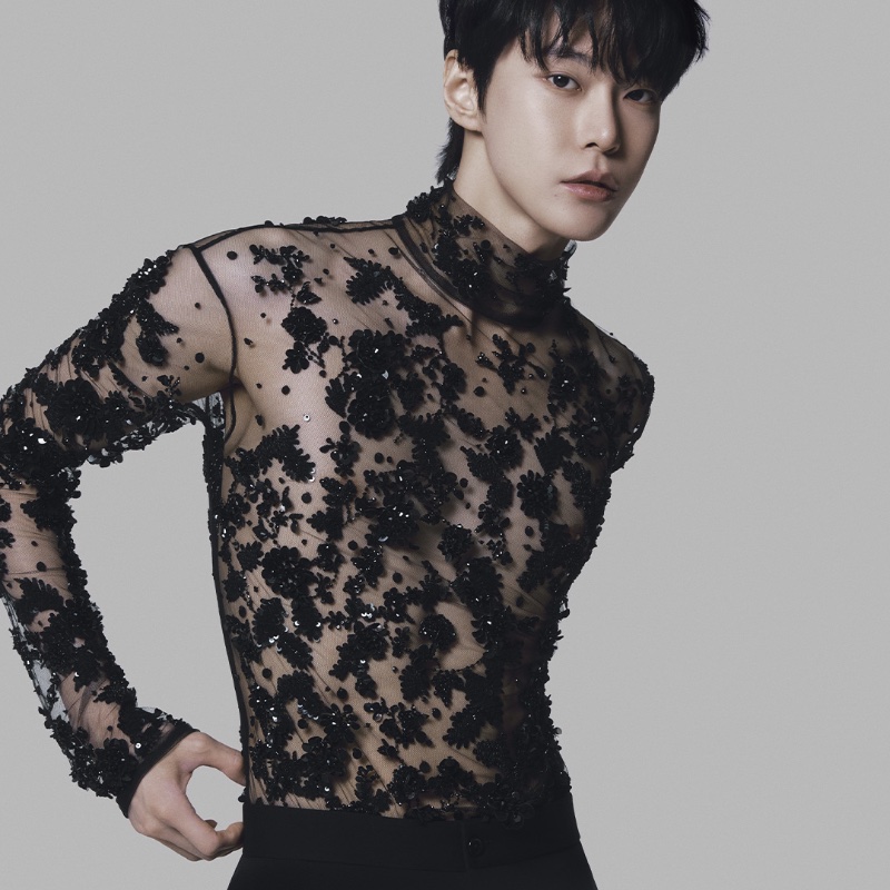 Doyoung wears a sheer sequined top for Dolce & Gabbana's fall-winter 2023 campaign. 