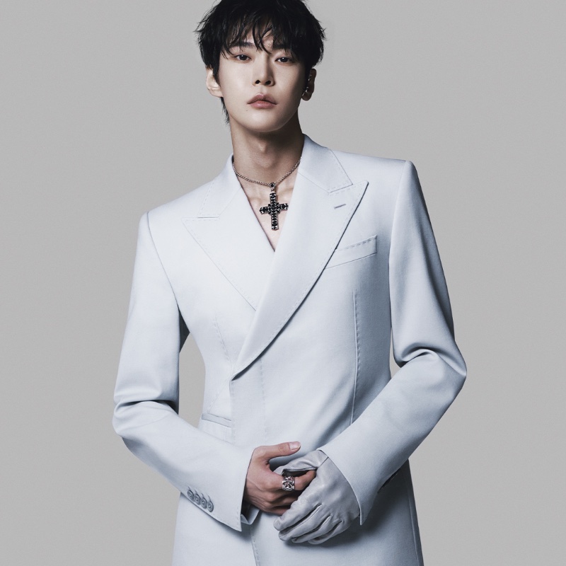 Donning a double-breasted coat, a leather glove, and Dolce & Gabbana jewelry, including a cross necklace, Doyoung fronts Dolce & Gabbana's fall-winter 2023 campaign.
