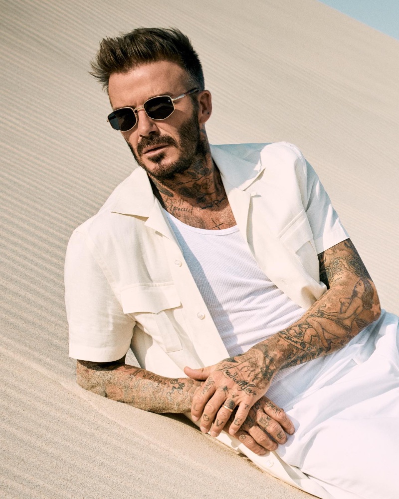 Embracing geometric lines, David Beckham wears the DB 1129/S Gold Honey Havana Green Mirror sunglasses.