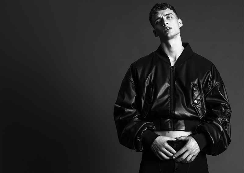 Taking the spotlight, Kai rocks a leather bomber jacket by Dolce & Gabbana.