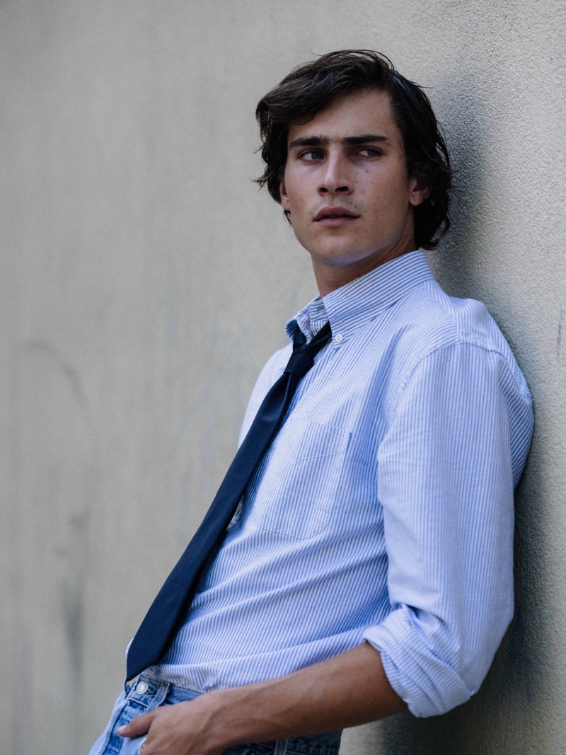 Liam Kelly wears a striped oxford shirt with a tie for the GANT 240 Mulberry Street collection campaign.