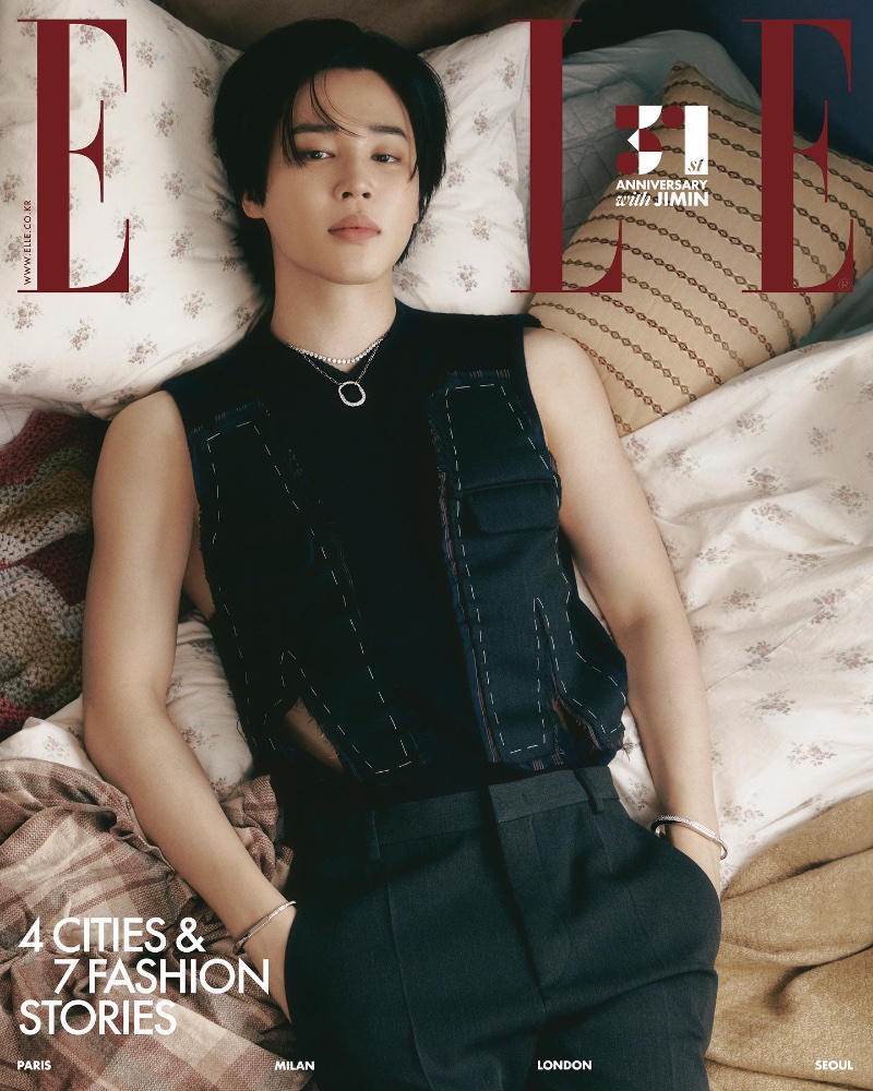 Jimin covers the November 2023 cover of Elle Korea, wearing a Tiffany & Co. Tiffany Lock pendant necklace in white gold with pavé diamonds. He also sports bangles from the brand.