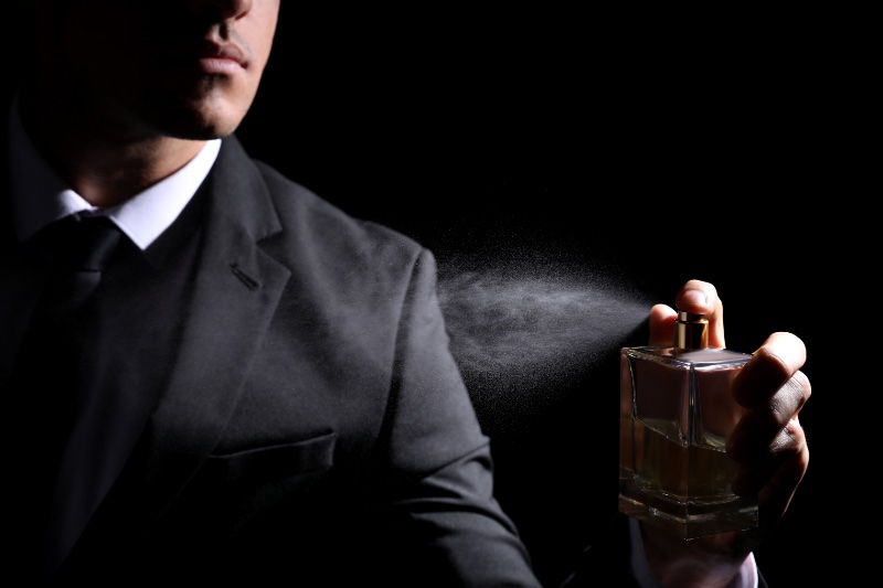 Man Spraying Cologne Suit