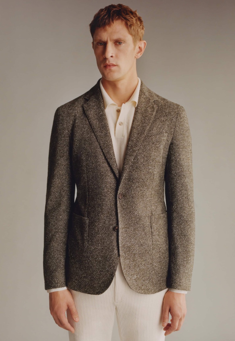 Mathias Lauridsen wears a Mango designed by Boglioli herringbone print virgin wool blazer. 
