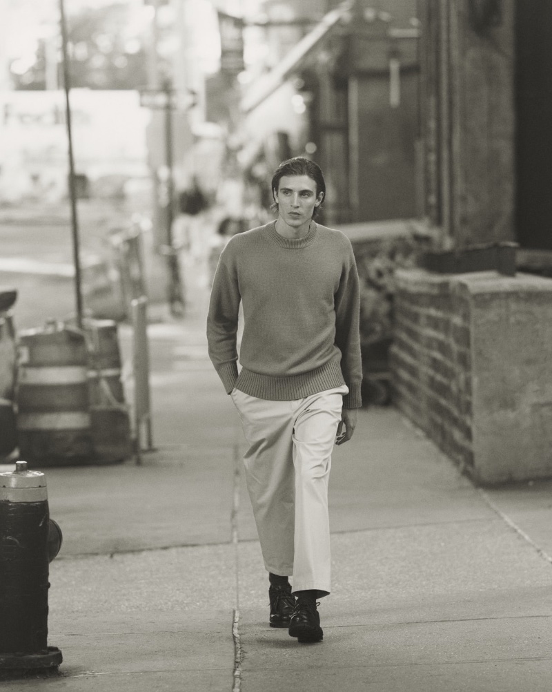 Model Joaquín Ibarra dons a cashmere sweater with wide-fit chino trousers and derby shoes.