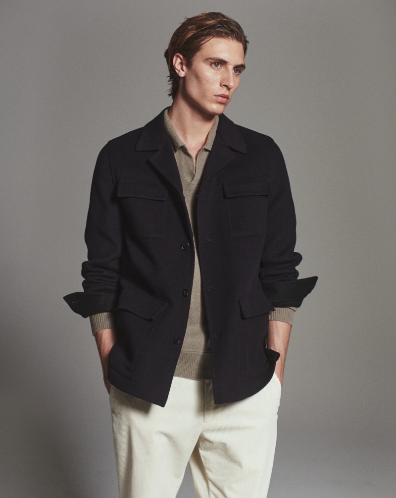 In front and center, Joaquín Ibarra wears a 100% wool overshirt with a wool-cashmere blend polo sweater and drawstring corduroy chino trousers. 