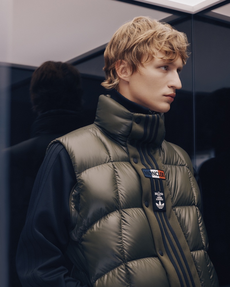 Model Nikita Stsjolokov wears a Moncler x adidas Originals Bozon nylon laqué padded vest over a three-stripe jersey zipped track jacket.