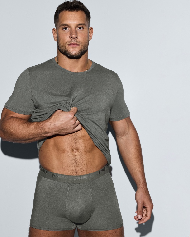 Wearing a matching t-shirt and boxer briefs, Nick Bosa appears in a SKIMS campaign. 