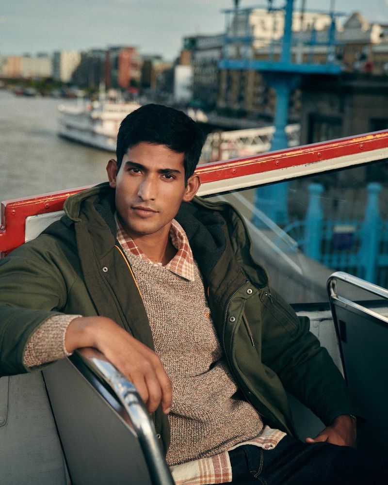 Pranav Bhargav is a smart vision in a sweater, flannel shirt, parka, and jeans for Pepe Jeans' fall-winter 2023 campaign. 
