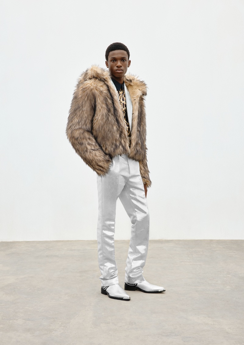 Ayomide Onasanya wears a faux fur hooded jacket with silver trousers from the Rabanne H&M collection.