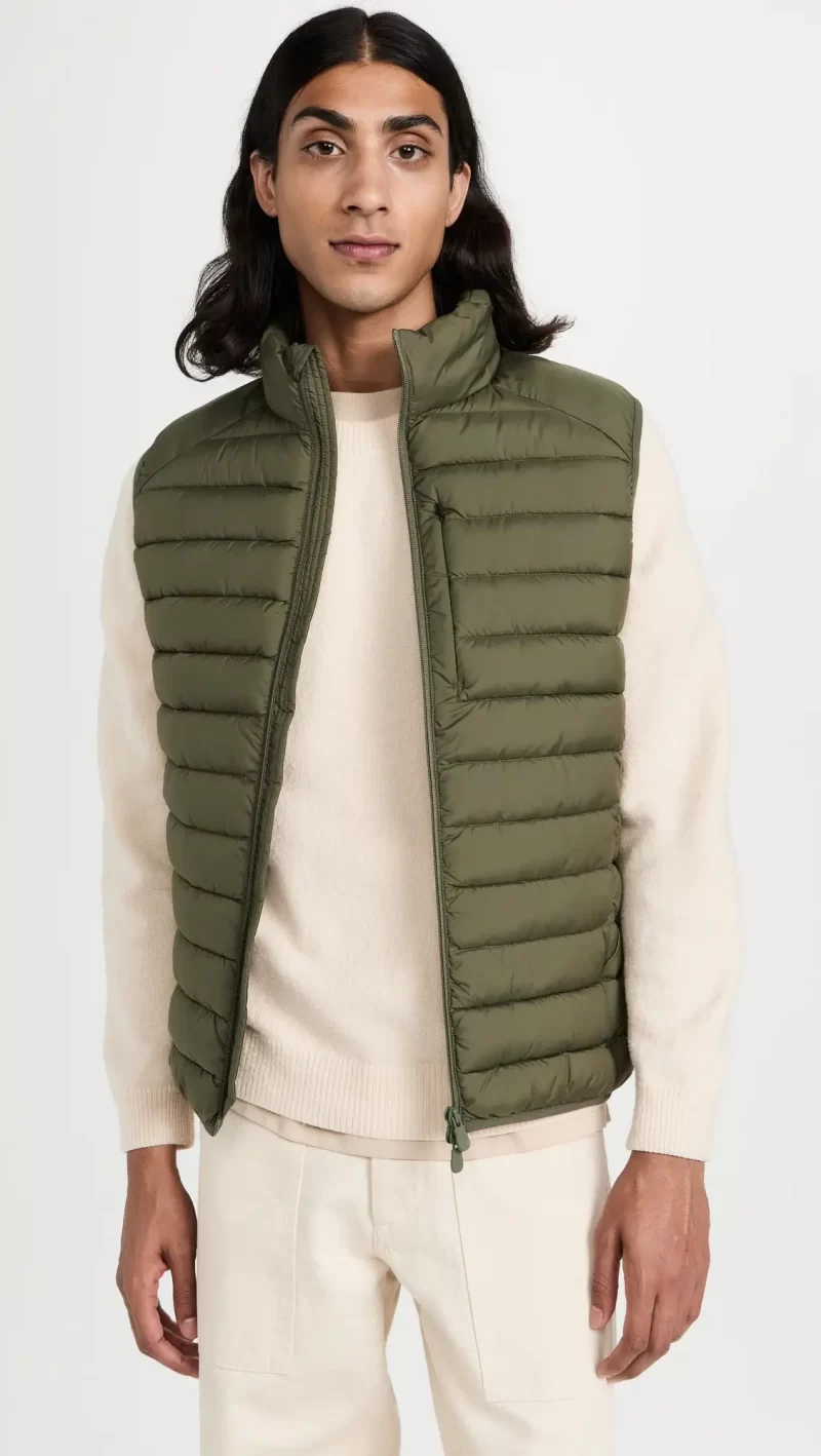 Layer a sweater with a quilted vest like this Save The Duck style for an effortless winter look.