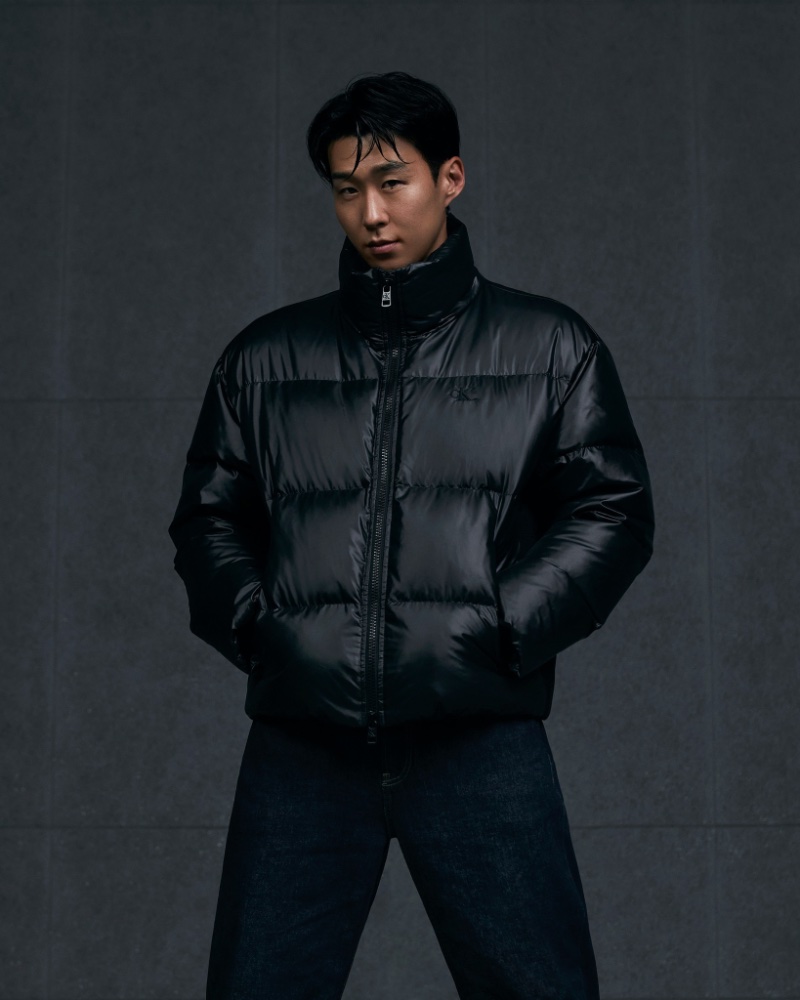 Son Heung-min sports a black Calvin Klein puffer jacket with jeans. 