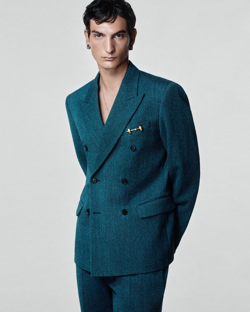 Luca Lemaire wears Versace's green moulinè wool double-breasted suit. 