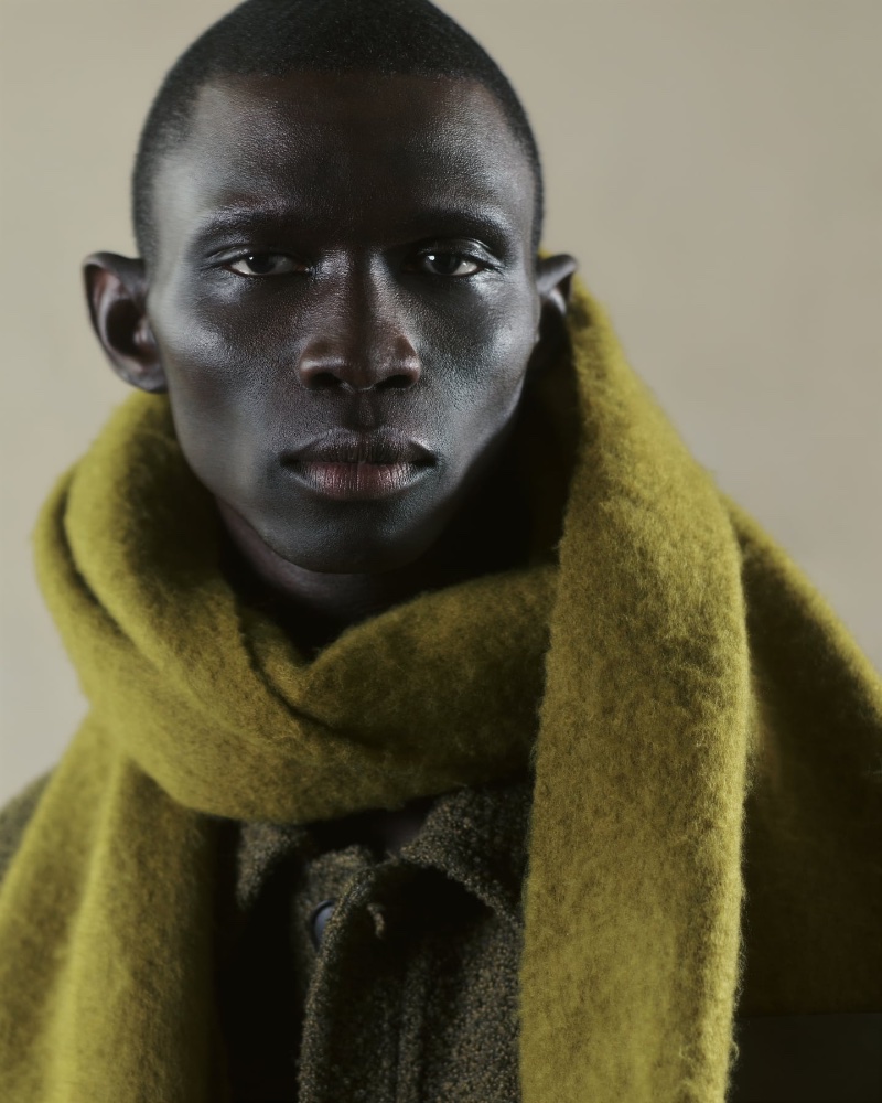 Fernando Cabral models a Zara brushed knit scarf over a bouclé textured jacket. 