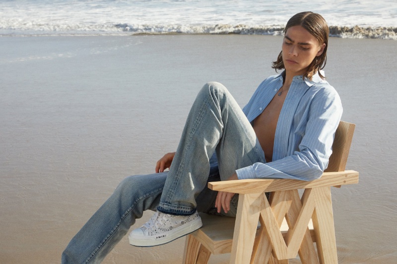 Model Sava Suvacarov hits the beach for AMIRI's denim campaign.
