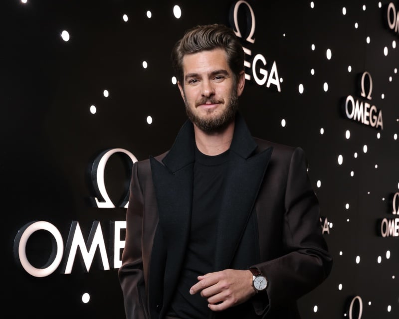 Capturing poise and luxury, Andrew Garfield shines at the OMEGA exhibition with his De Ville Prestige Co-Axial timepiece.