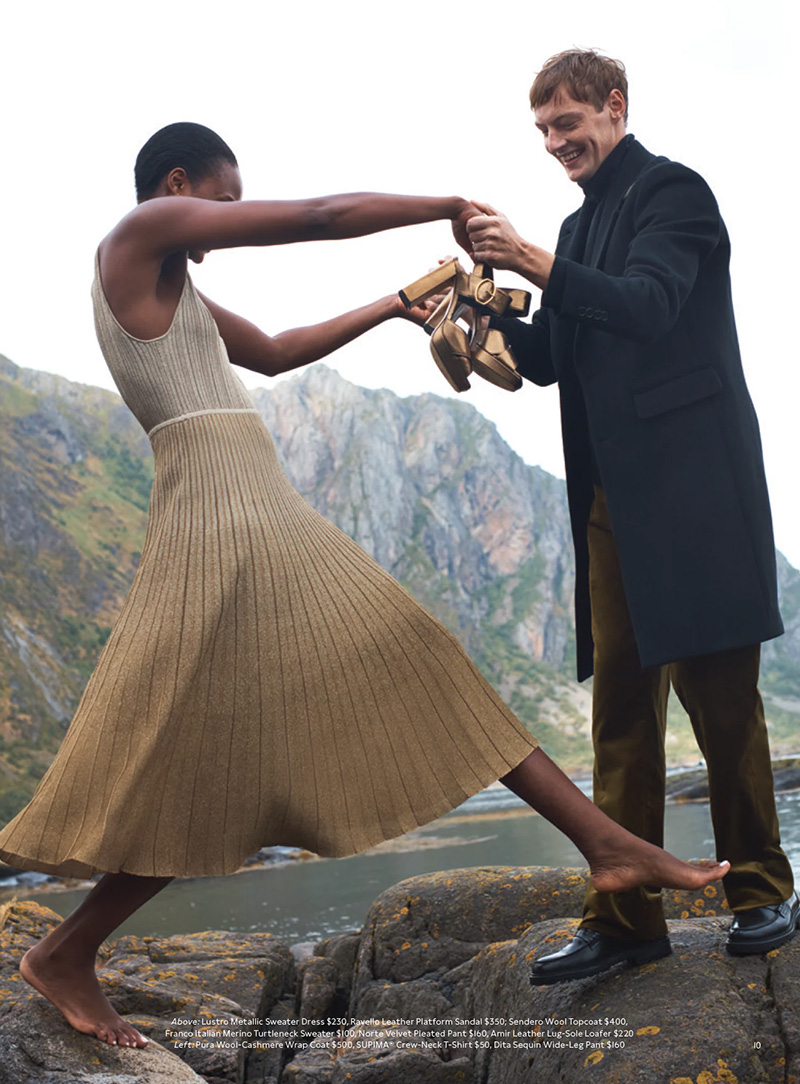 A playful moment captured as Roberto Sipos engages in a festive tug-of-war with a companion, both dressed in Banana Republic's holiday finest against a majestic mountainous vista.