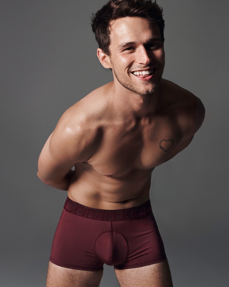 All smiles, Brandon Flynn stars in Calvin Klein's holiday 2023 advertisement.