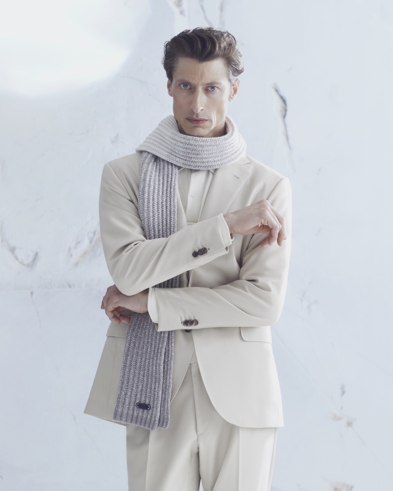 Jonas Mason dons Brioni's ivory silk gabardine Plume suit with a ribbed scarf.