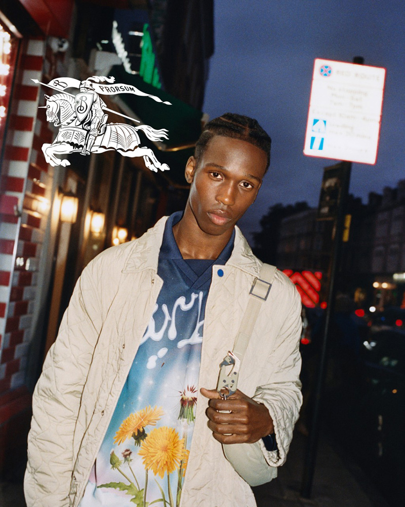 Rakim Janneh brings a certain cool to Burberry's spring 2024 campaign, pairing a graphic tee with a sleek jacket against the dusk-lit streets of the city. 