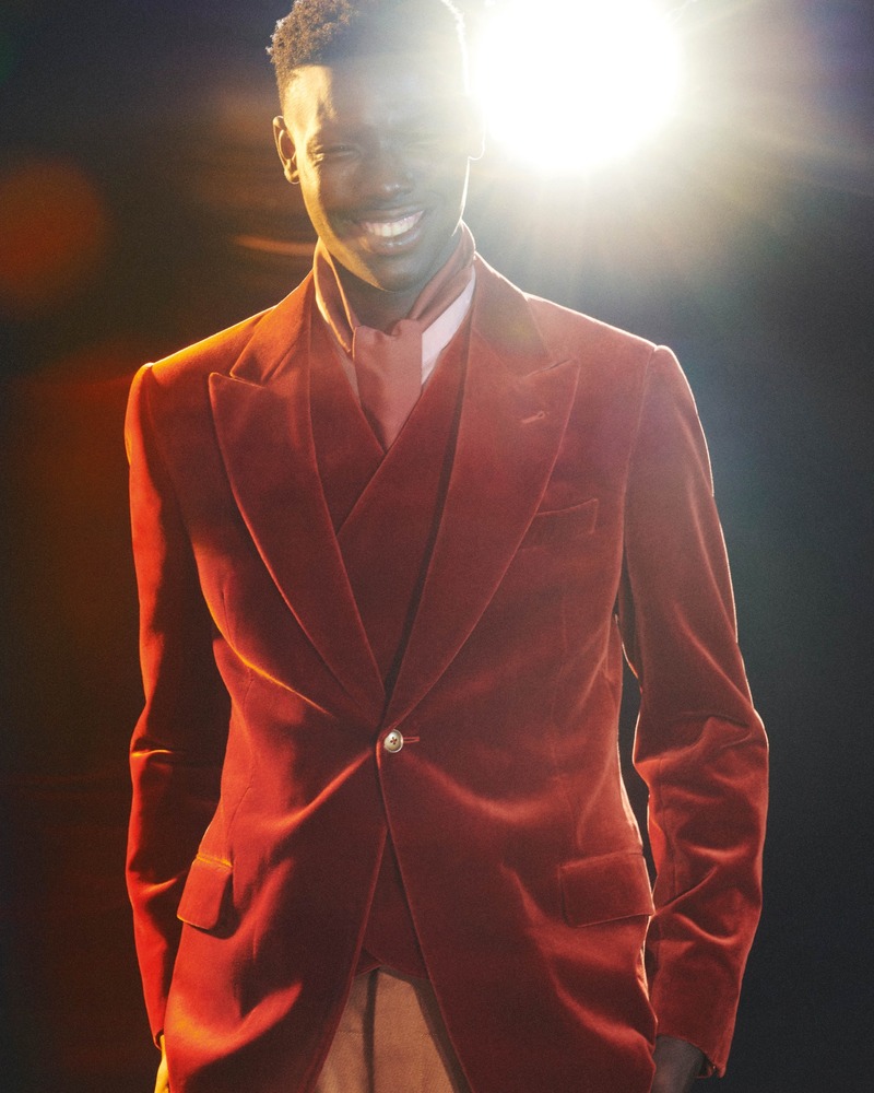 Victor Shalomi is all smiles in a red velvet ensemble for Emporio Armani's holiday 2023 campaign.