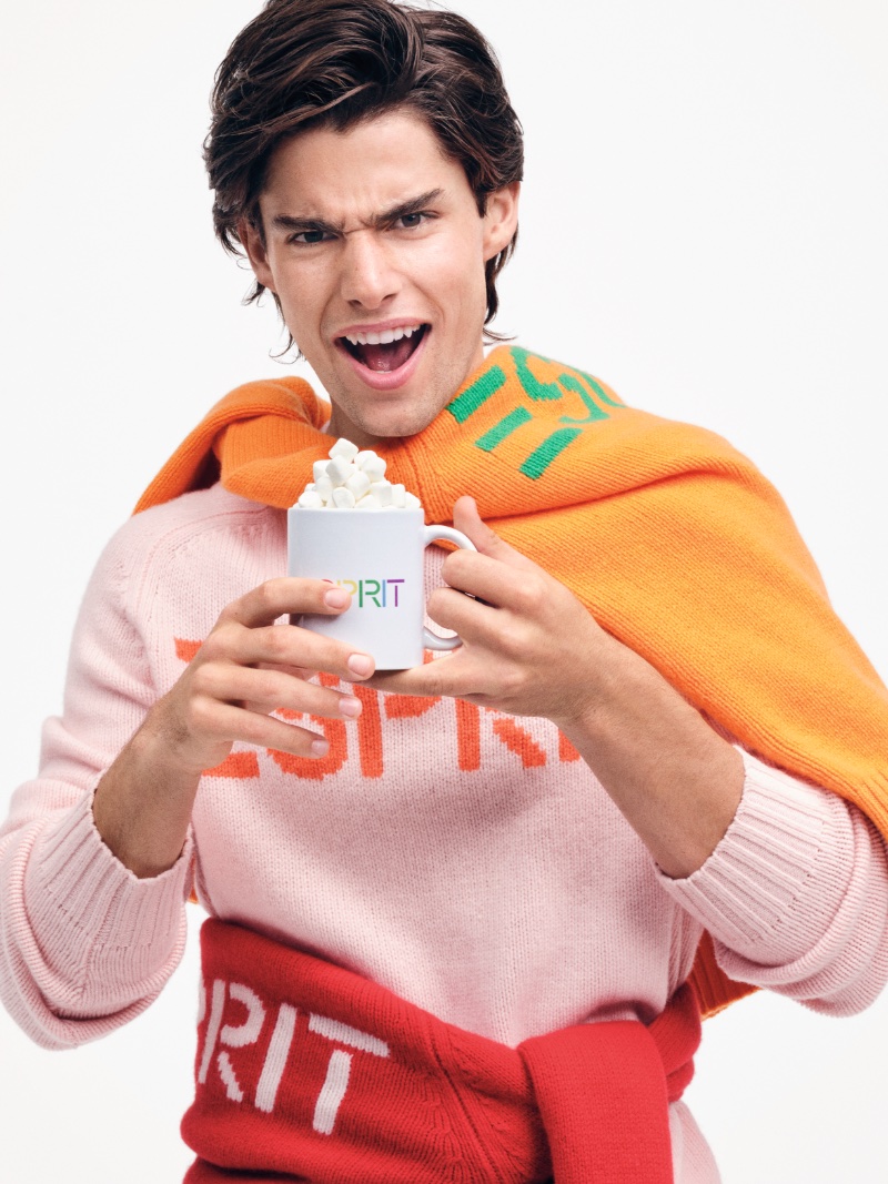 Corrado Martini sports colorful sweaters for Esprit's holiday 2023 campaign.